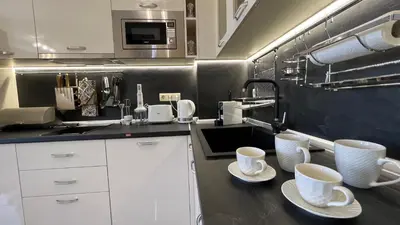 a kitchen with two white cups and saucers on a counter at Bratanov Vip Zone maisonettes 606 & 609 in Sunny Beach