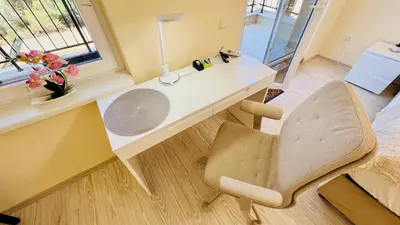 a white desk with a chair and a lamp at Bratanov Vip Zone maisonettes 606 & 609 in Sunny Beach