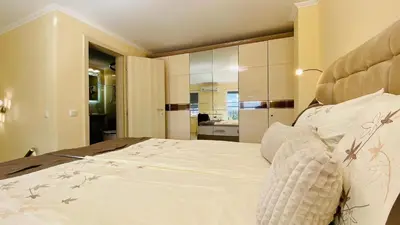 a bedroom with a large bed and a bathroom at Bratanov Vip Zone maisonettes 606 & 609 in Sunny Beach