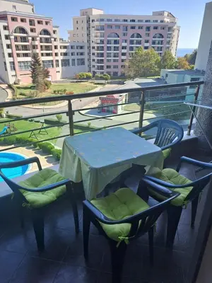 a table and chairs on top of a balcony at SUNNY BEACH PLAZA Apartments in Sunny Beach