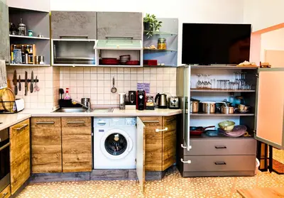 a kitchen with a washer and a washing machine at Two Bedroom Apartment - Alexandrovska - Top Location - Central Bus, Train and Marine Stations, next to Sea Garden and Beach in Burgas City