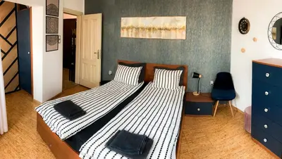 a bedroom with two beds and a blue wall at Two Bedroom Apartment - Alexandrovska - Top Location - Central Bus, Train and Marine Stations, next to Sea Garden and Beach in Burgas City
