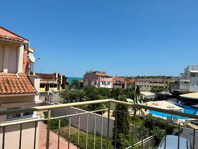 a balcony with a view of a pool and buildings at Private One-Bedroom Apartment with Balcony in Sozopol by Flat Mаnаger in Sozopol