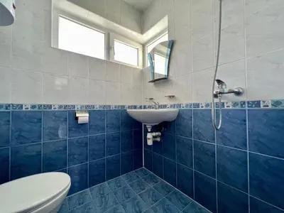 a blue and white bathroom with a sink and a toilet at Private One-Bedroom Apartment with Balcony in Sozopol by Flat Mаnаger in Sozopol
