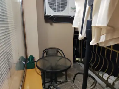 a table and a chair in a room with a microwave at Kamelya Guest Studio in Nesebar