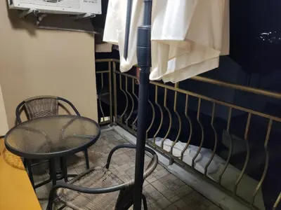 a chair and a table in a room at Kamelya Guest Studio in Nesebar