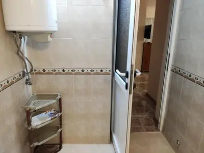 a bathroom with a shower with a door open at Kamelya Guest Studio in Nesebar
