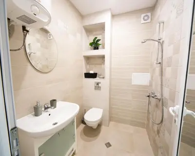 a bathroom with a sink and a toilet and a shower at Aleks Sunrise -Top Center ,Sea Garden in Burgas City