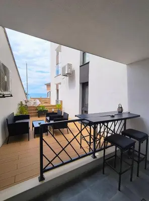 a balcony with a table and chairs on a building at Antique 7 ap.1 in Sozopol