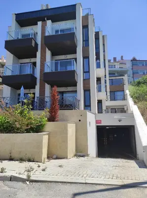 an apartment building with a garage in front of it at Antique 7 ap.1 in Sozopol