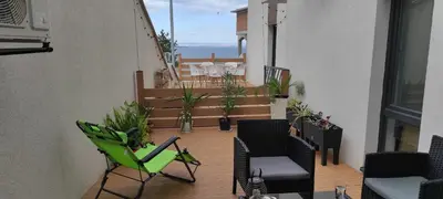a balcony with chairs and a patio with a view of the ocean at Antique 7 ap.1 in Sozopol
