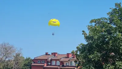 a kite is flying in the sky over houses at Oasis deluxe apartment by the sea in Ravda