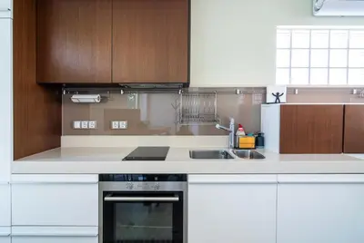 a kitchen with a sink and a stove and cabinets at Happy-U house - Modern and with stunning view in Chernomorets