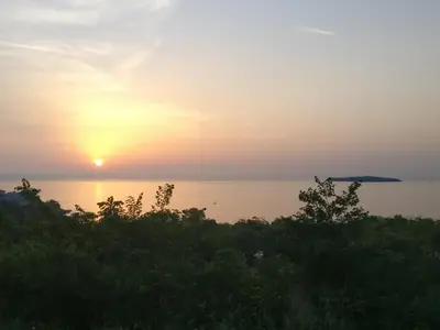 a sunset over a body of water at Happy-U house - Modern and with stunning view in Chernomorets