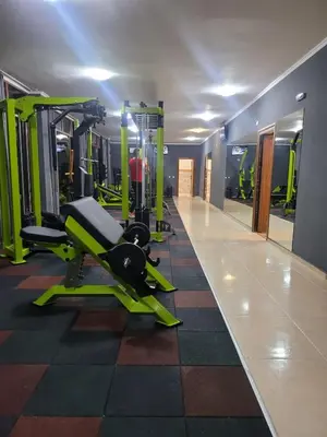 a gym with green tread machines in a room at Famagusta Antoniya in Aheloy