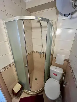 a small bathroom with a shower and a toilet at Summer Breeze 515 Studio NO ROMANIA in Sunny Beach