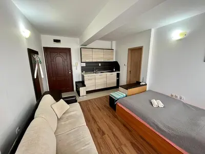 a bedroom with a bed and a couch and a sink at Summer Breeze 515 Studio NO ROMANIA in Sunny Beach