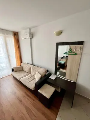 a living room with a couch and a mirror at Summer Breeze 515 Studio NO ROMANIA in Sunny Beach