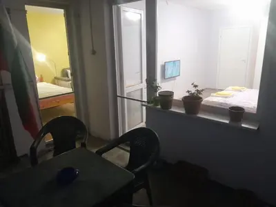 a room with a table and two chairs and a mirror at Summer Burgas Appartment in Burgas City