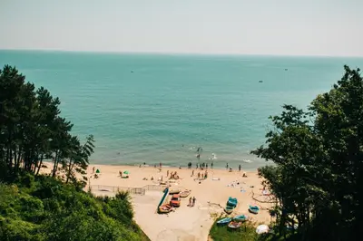 a group of people on a beach near the ocean at Moreto Seaside Aparthotel in Obzor