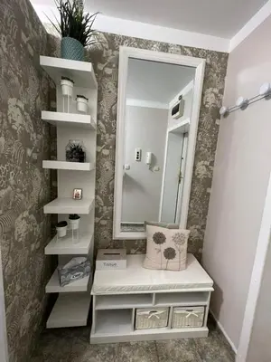 a bathroom with white shelves and a mirror at Luxury Apartments Ani in Burgas City