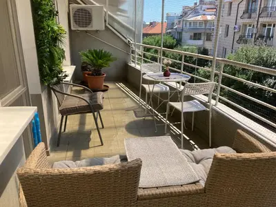 a balcony with chairs and a table on a balcony at Luxury Apartments Ani in Burgas City