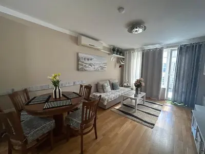 a living room with a table and a couch at Luxury Apartments Ani in Burgas City