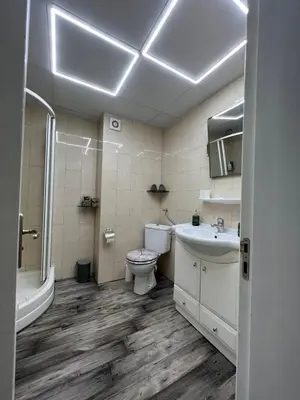 a bathroom with a toilet and a sink and a tub at Luxury Apartments Ani in Burgas City
