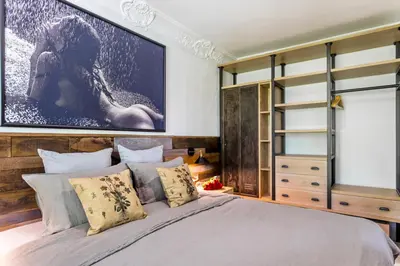 a bedroom with a large painting above a bed at Castro Mesembria Boutique Hotel in Nesebar