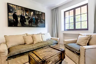 a living room with a couch and a picture on the wall at Castro Mesembria Boutique Hotel in Nesebar