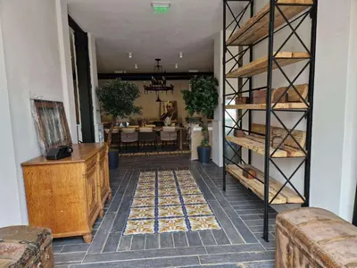 a dining room with a table and a room with a shelf at Castro Mesembria Boutique Hotel in Nesebar