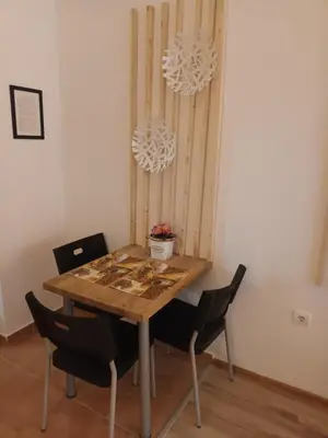 a dining room with a table with chairs and a chandelier at APARTMENT DELUXE MARINA CAPE 4 stars complex 33 6 in Aheloy
