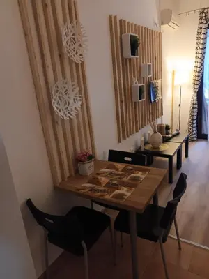 a dining room with a wooden table and chairs at APARTMENT DELUXE MARINA CAPE 4 stars complex 33 6 in Aheloy