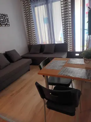 a living room with a table and a couch at APARTMENT STUDIO DELUXE MARINA CAPE 4 stars resort 33 5 in Aheloy