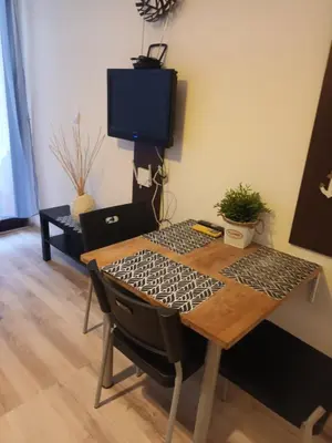 a table and chairs with a television in a room at APARTMENT STUDIO DELUXE MARINA CAPE 4 stars resort 33 5 in Aheloy