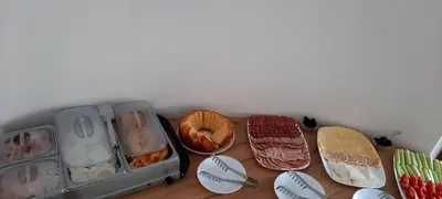 a table topped with trays of different types of food at Къща за гости Вивиан in Kiten
