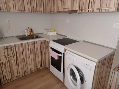 a kitchen with a washing machine and a sink at Апартамент Желева in Pomorie