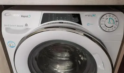 a washing machine with a clock on top of it at Апартамент Даскала с паркомясто in Burgas City