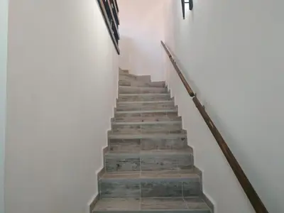 a flight of stairs in a white building at Къщата с разкопките - The house with the excavations in Sozopol