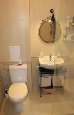 a bathroom with a toilet and a sink at Pomorie Residence 1-bedroom apartment with pool & free parking, 300 m to the beach in Pomorie