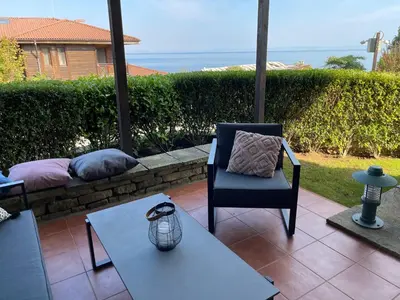 a patio with a chair and a table at Sozopolis Cliffs Luxury Seaview Villa in Sozopol