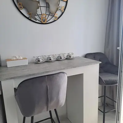 a table with a chair and a mirror on the wall at Salvia in Ravda