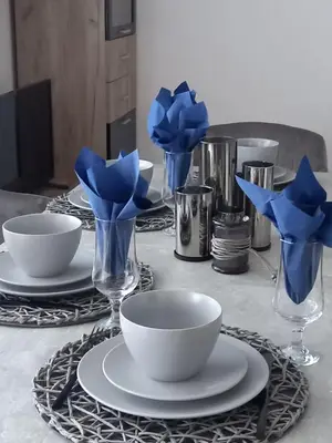 a table with plates and vases with blue flowers in them at Salvia in Ravda