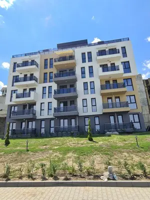 an apartment building with a lawn in front of it at Gold beach apart Obzor in Obzor