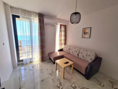 a living room with a couch and a table at Cactus beach apart Obzor in Obzor