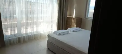 a bedroom with a bed with two towels on it at Swan Bay complex in Chernomorets