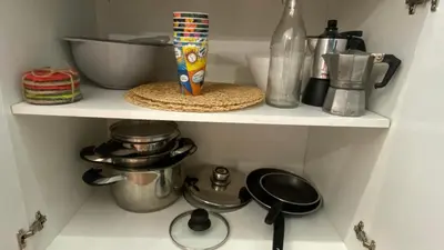 a shelf in a kitchen with pots and pans at KALIA A16 Private One Bedroom Apartment in Sunny Beach