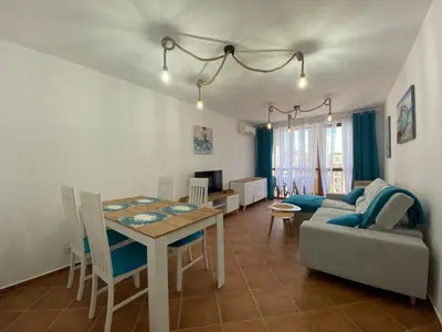 a living room with a table and a couch at KALIA A16 Private One Bedroom Apartment in Sunny Beach