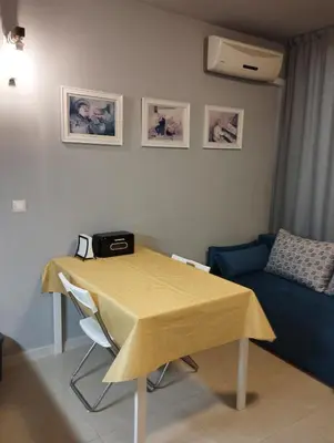 a living room with a table and a couch at Casa do Farol - апартамент с басейн до плажа на къмпинг 