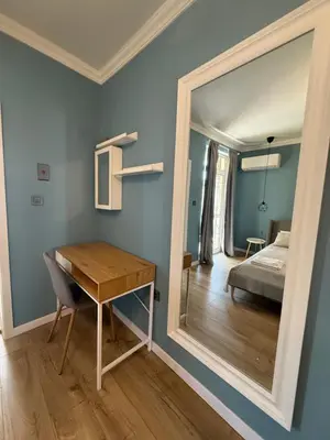 a room with a mirror and a desk and a bed at Chernomorets Apartment in Chernomorets